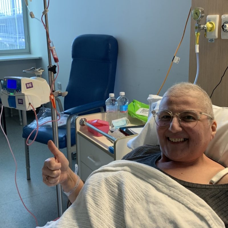 Woman in hospital bed smiling