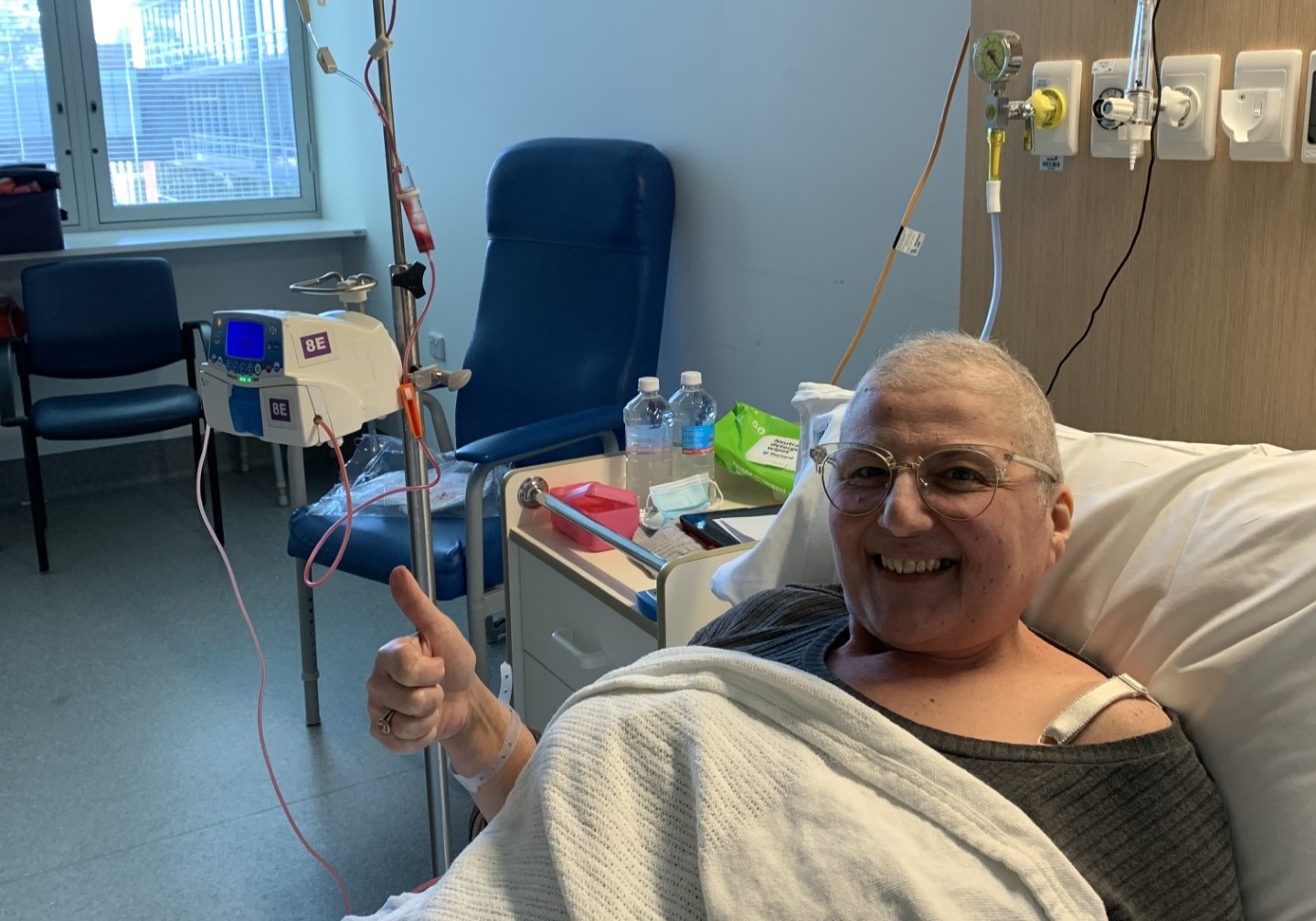 Woman in hospital bed smiling